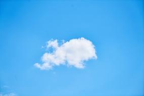 a lonely cloud floating in the blue sky.