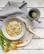 healthy porridge against the backdrop of yellow tulip