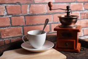 vintage coffee grinder with mug