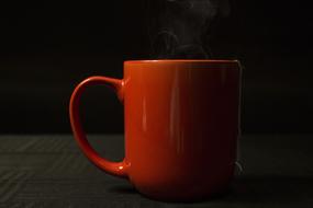 orange mug on black background