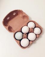 white raw eggs in a box