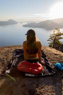 girl on a blanket at the edge of a cliff