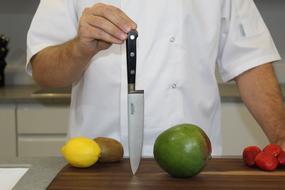 chef with fruit and a knife