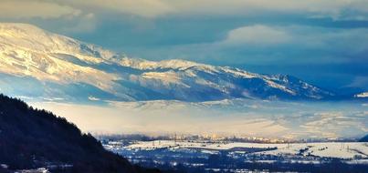 a beautiful landscape of mountains in the clouds