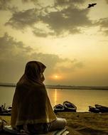 Human on lake shore at dusk