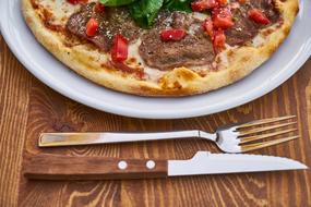 photo of pizza, fork and knife on the table