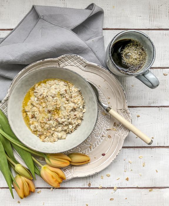 healthy porridge against the backdrop of yellow tulip