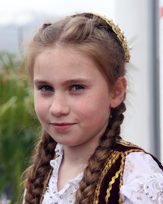 girl with pigtails in traditional dress in Albania