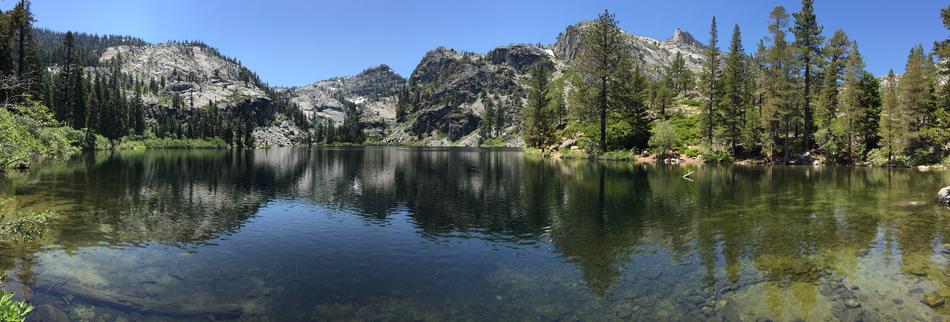 landscape of a lake with mountains in the forest