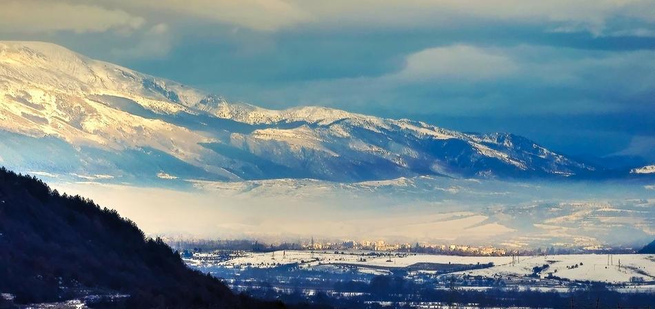 a beautiful landscape of mountains in the clouds
