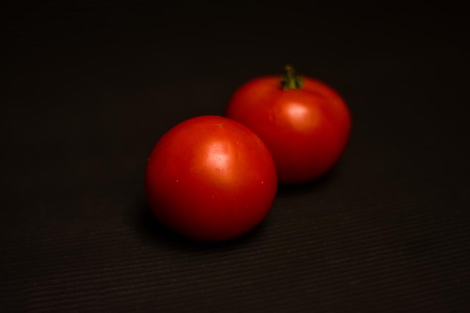 fresh tomatoes on a black background