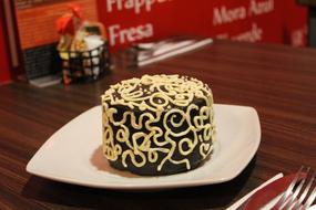 Chocolate dessert decorated with white filling