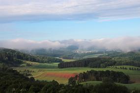 the meadow is green in the clouds