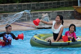 happy asian children playing in the pool