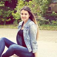 a pretty girl sitting in the park