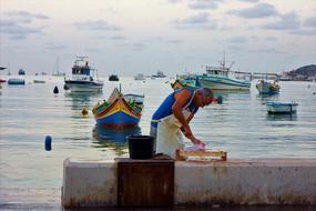 man slicing meat against the sea