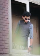 man in sunglasses looking out of the window