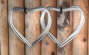 silver jewelry on a wooden fence