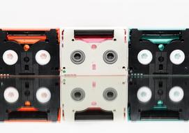 Close-up of the colorful mini dv cassettes, with the reflections, at white background