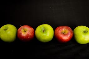 juicy apples on a black background
