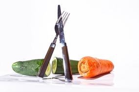 kitchen utensils with vegetables