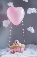 Baby in balloon Basket