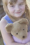 Cute, blonde child girl with the beautiful teddy bear