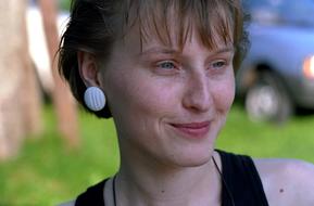 smiling woman with white earrings