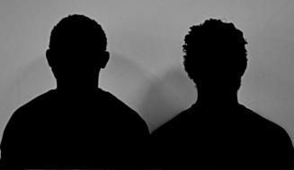 black Silhouettes of man and Woman at grey background