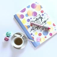 colorful notebook with a coffee mug