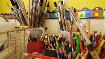 brushes, pencils and paints at art school