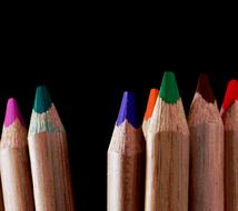 Colorful, wooden pencils at black background