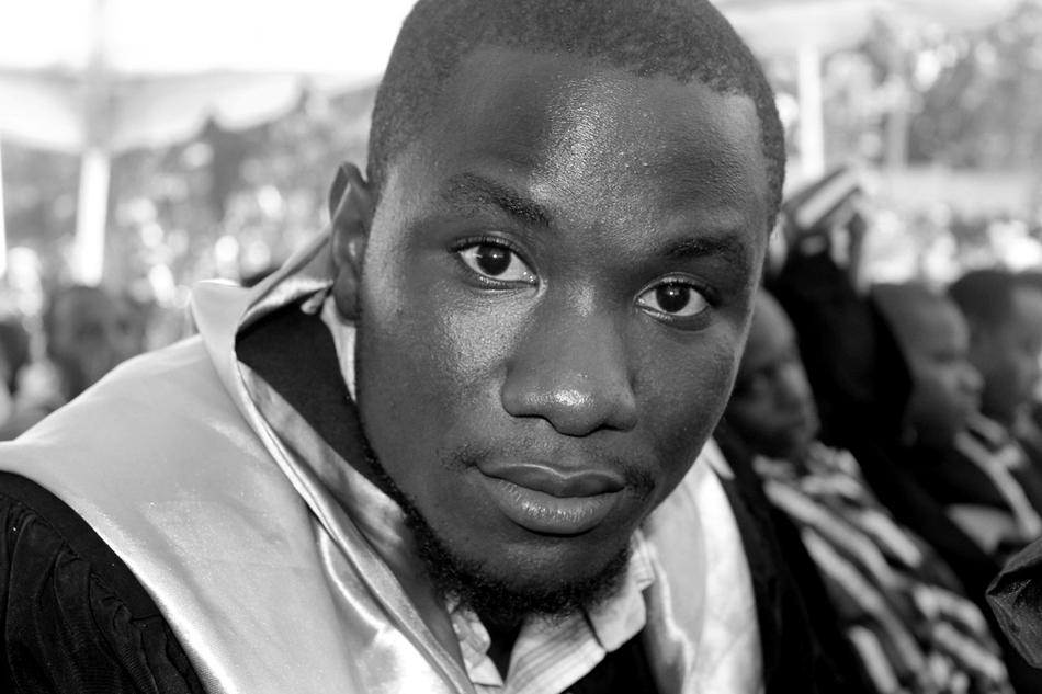 portrait of african american graduate on blurred background