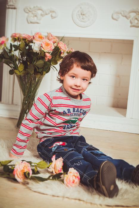 Baby Boy Sitting near fireplace