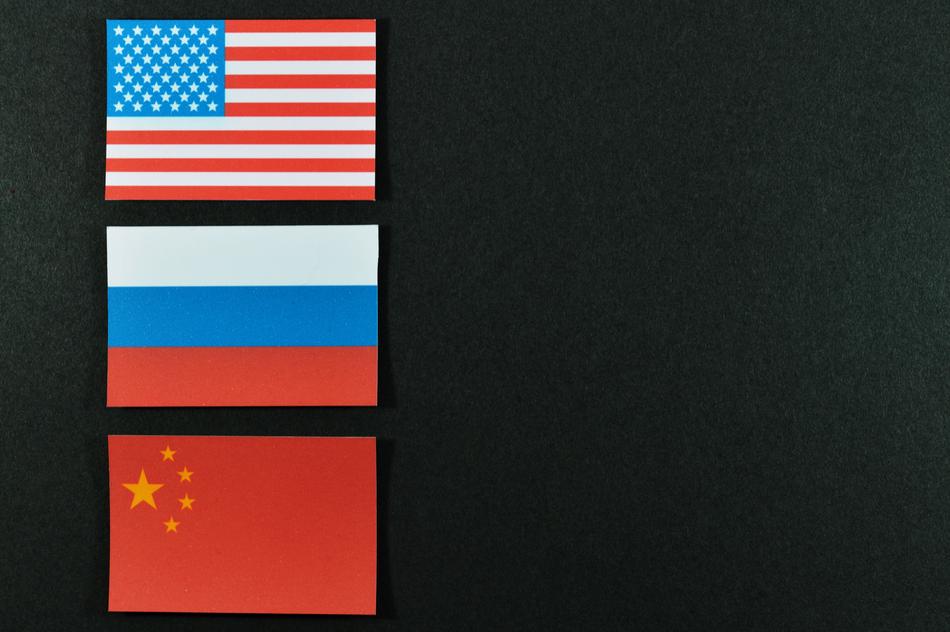 Flags of USA, Russia and China, at dark background, clipart