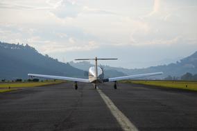 a silver airplane on the road