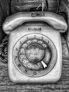 photo of retro wired phone on wallpaper