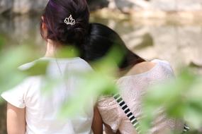 Friends, two school Girls, back view in a blurred background