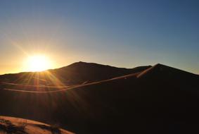 the sun is shining in the mountains and sands