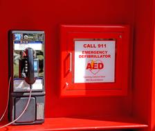 Emergency telephone, near the red and white sign on the locker