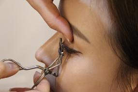 female face, eyelash curlers