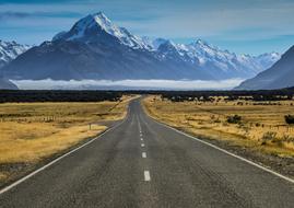 road with field and mountain view