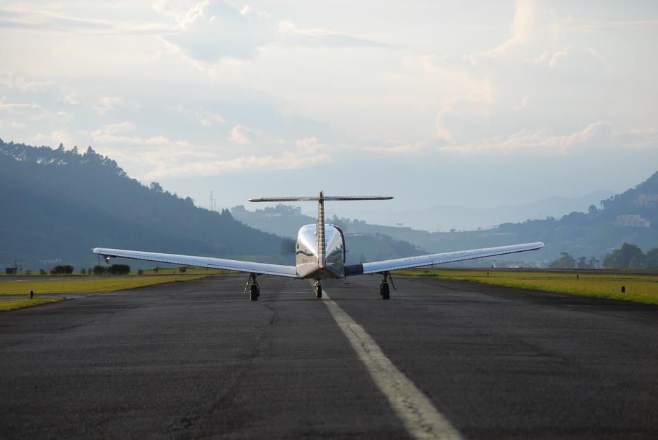 a silver airplane on the road