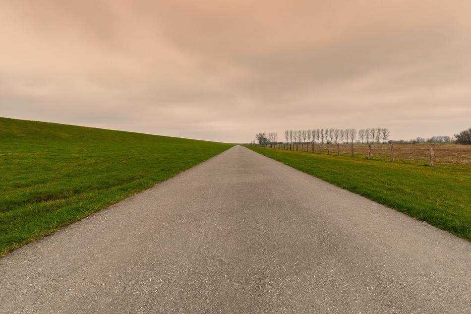 a grass road leading into the distance