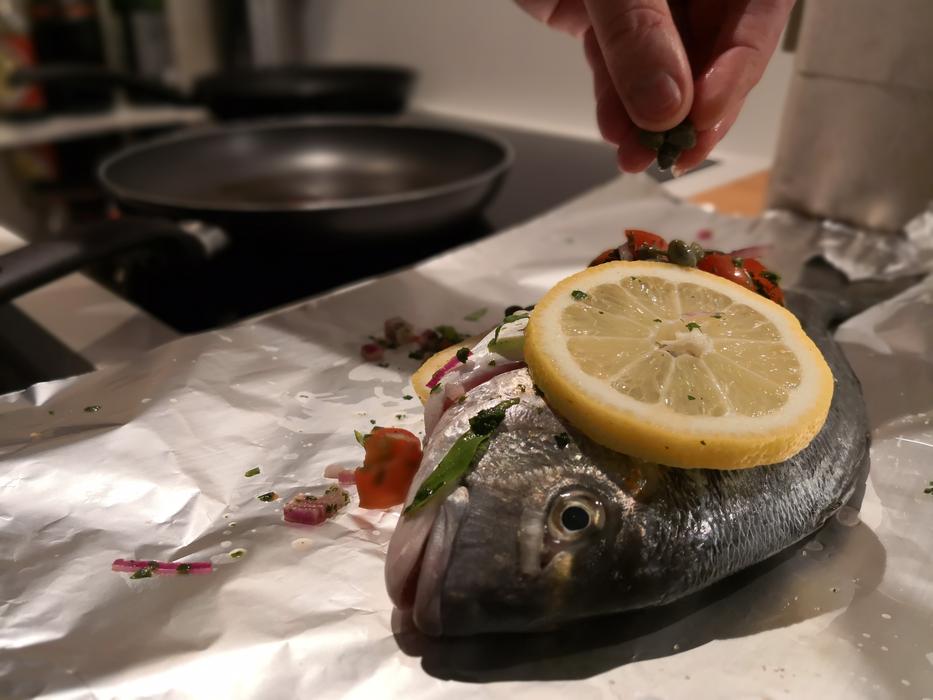 Boiled fish with lemon