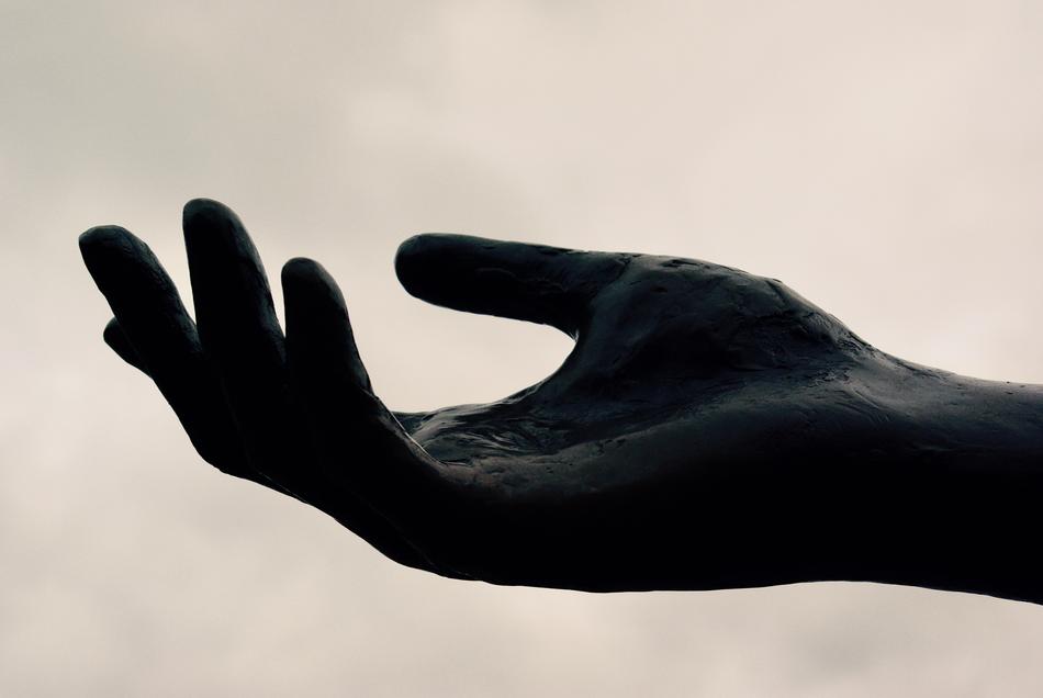 Black and white photo with close-up of the open hand, in shadow
