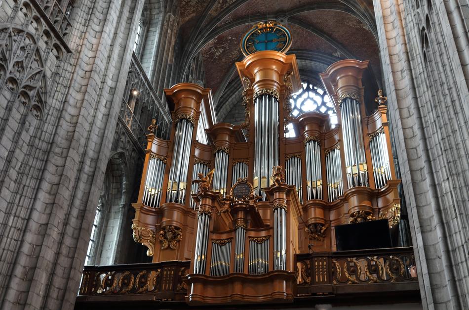 a beautiful church with an organ inside.