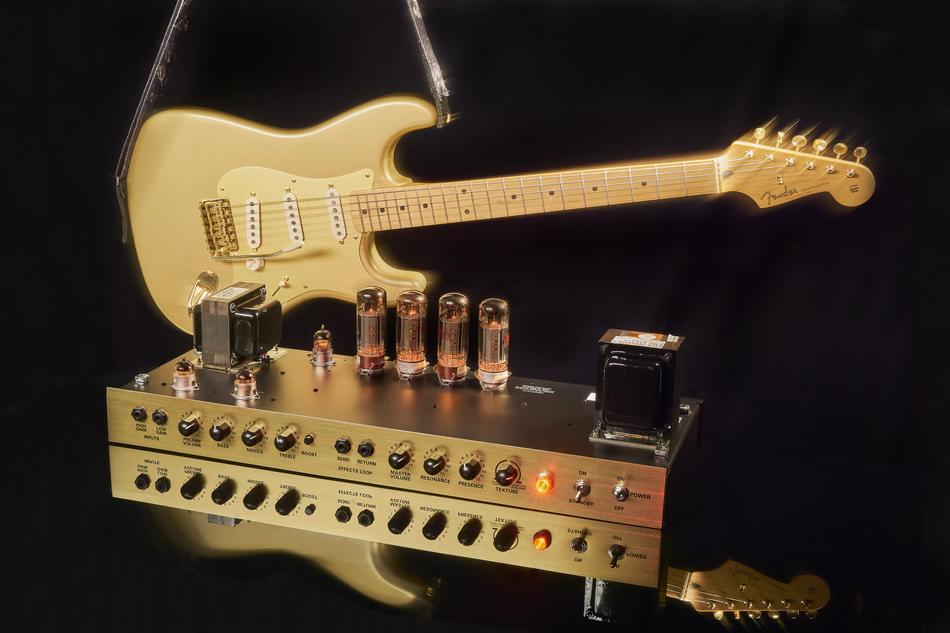gold guitar with amplifier on black background