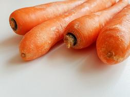 peeled carrots on a white background