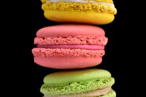 colored macarons on a black background